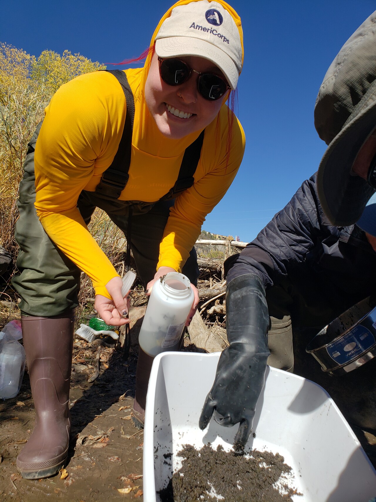 AmeriCorps member serving at Mountain Studies Institute smiles during a water quality event