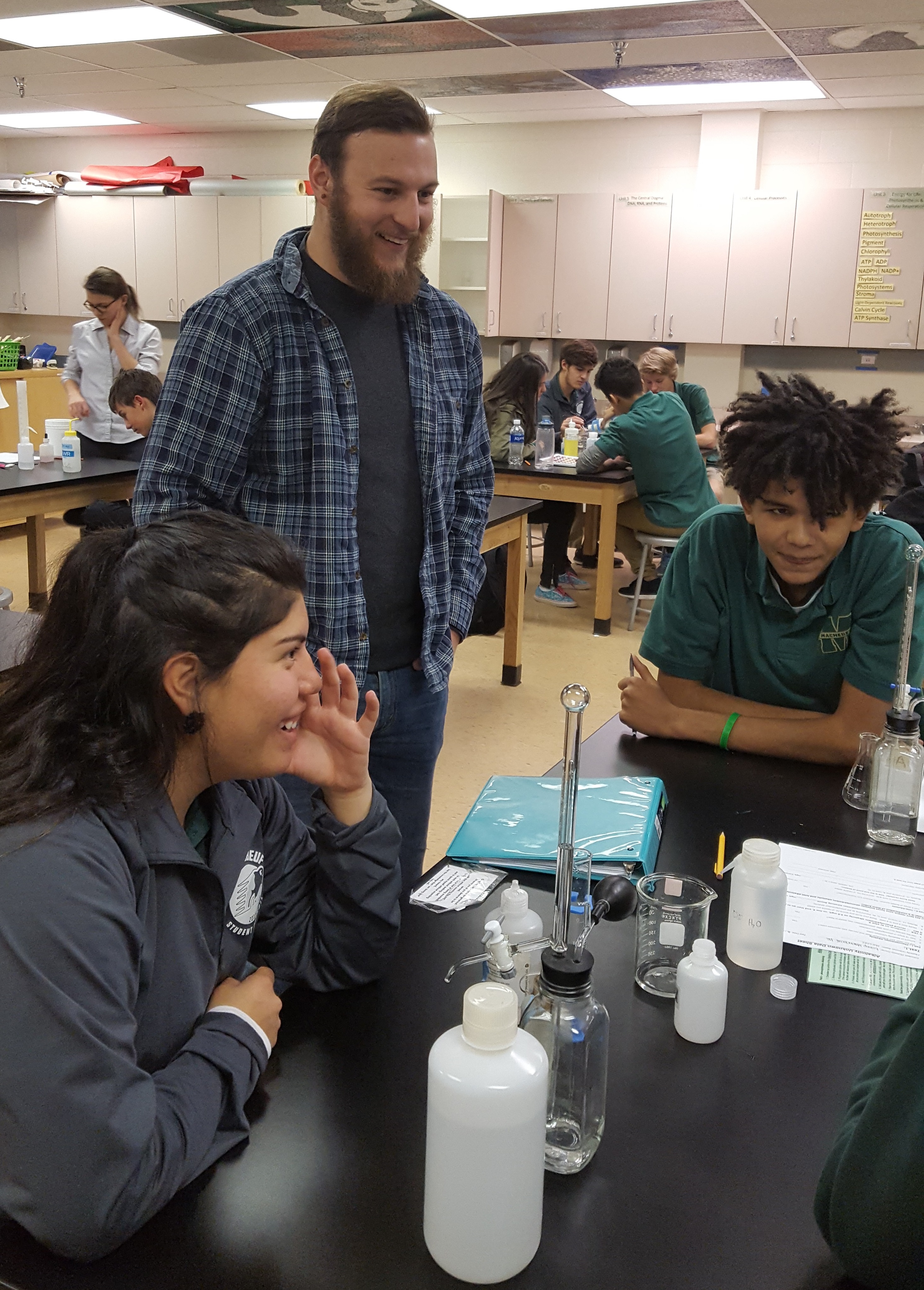 River Watch participants and instructor smile at a lab table