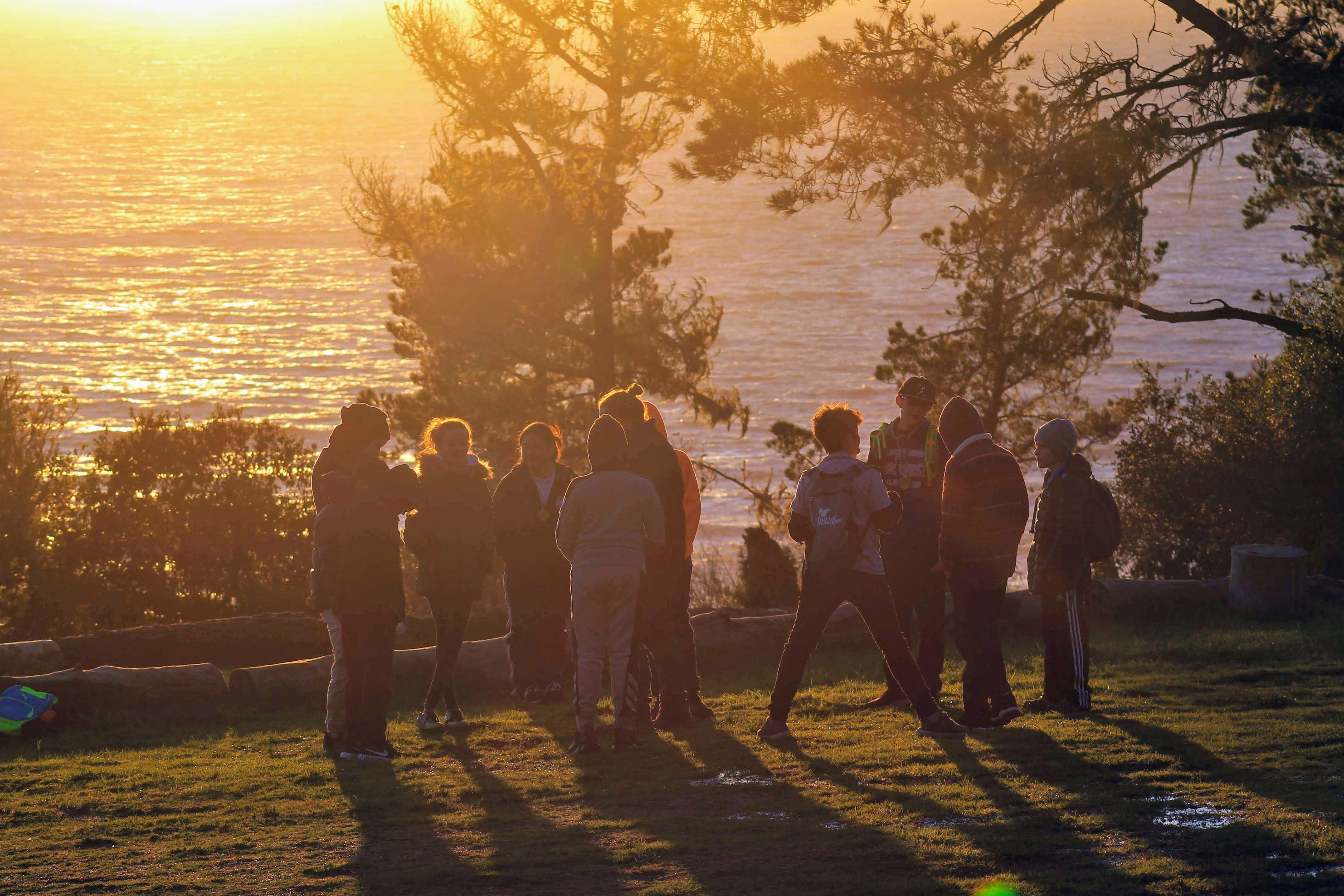 campers playing a game at sunset